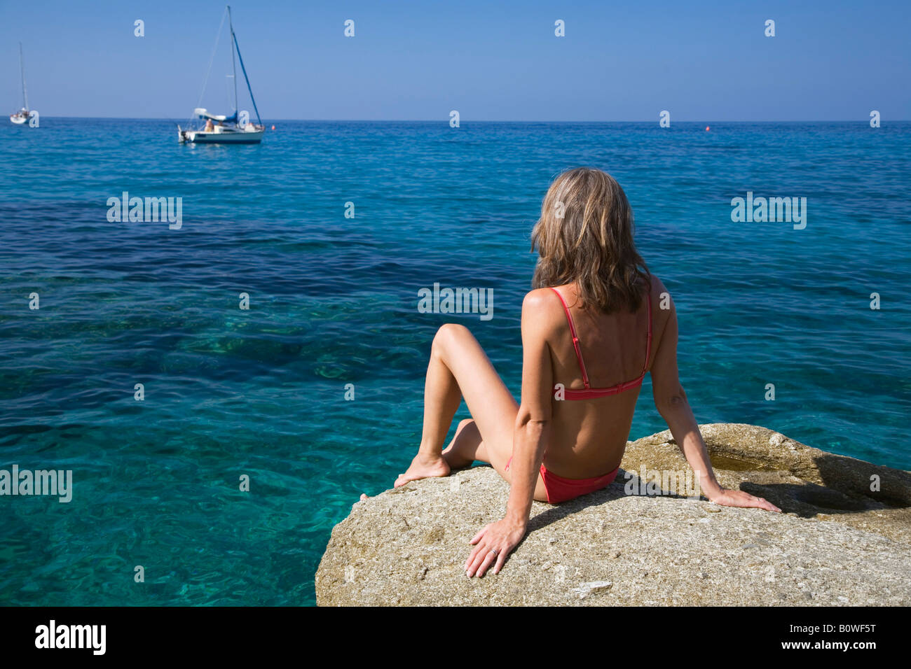 Frau Sonnenbaden auf einem Felsen, Spiaggia di San Andrea, Elba, Italien, Europa Stockfoto