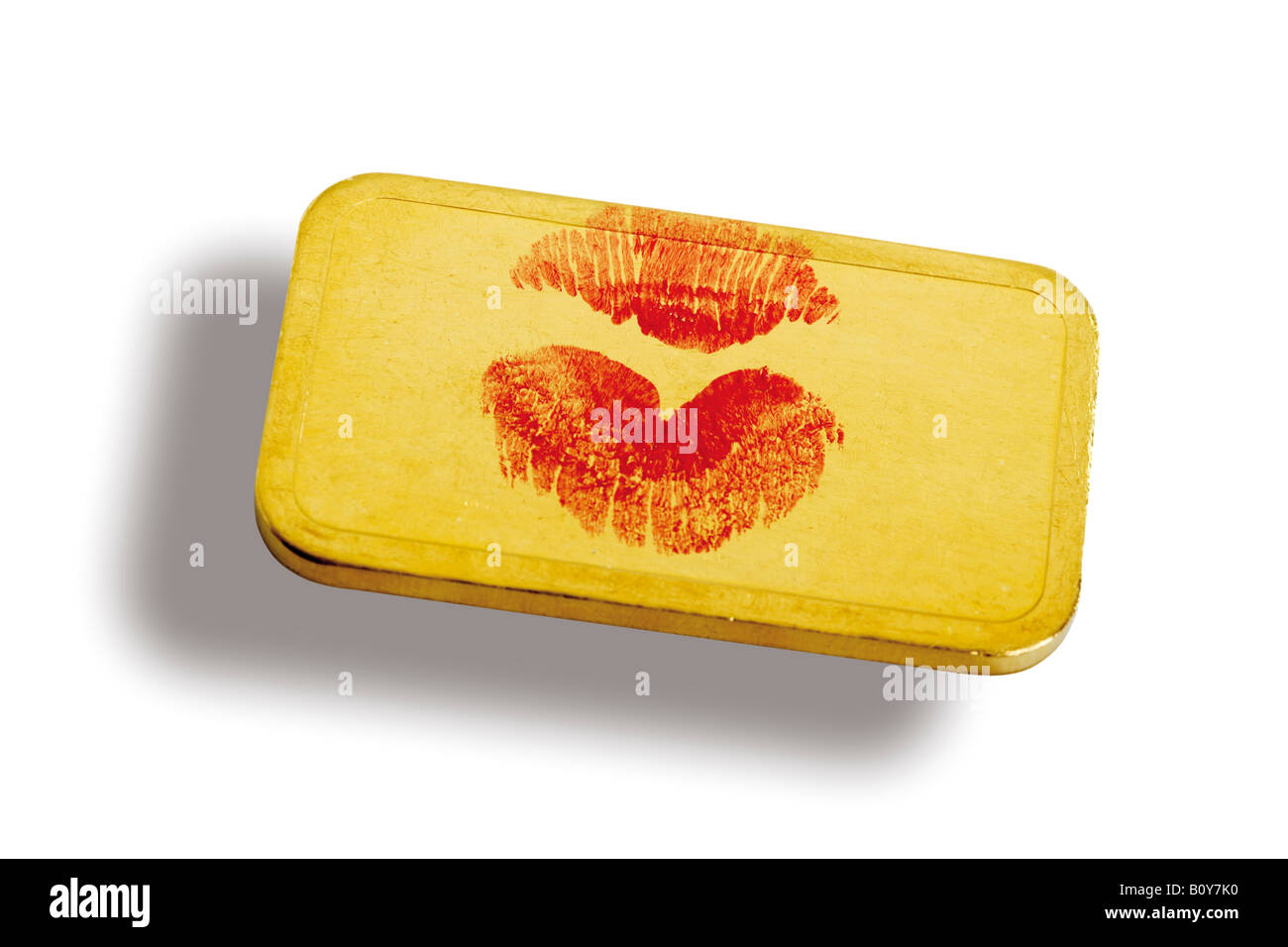 Lippenstift-Kuss in Goldbarren Stockfoto