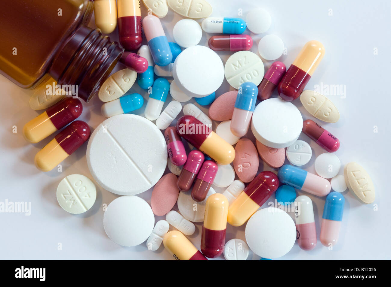 Eine Auswahl von Tabletten und Kapseln verschüttet aus einem Medikament - Flasche - Konzept - Polypharmazie, mehrere Medikamente, Medikamente, über Rezept Stockfoto