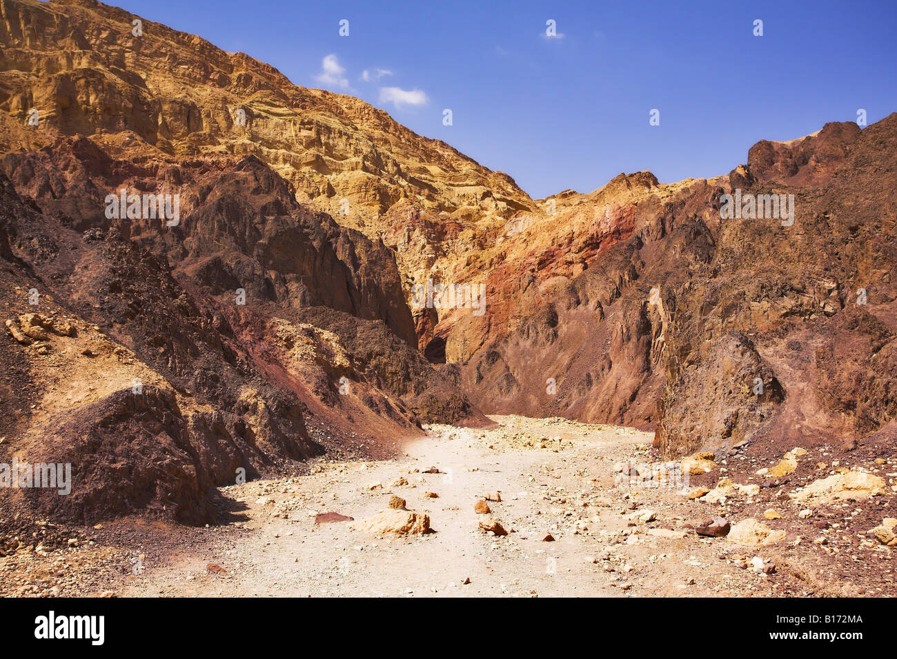 Straße zwischen geologischen Schichten in Steinwüste im Süden Stockfoto