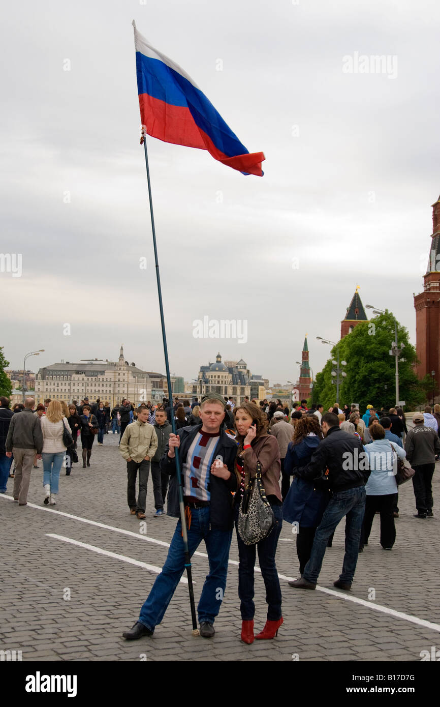 Patriotische russische paar mit Flagge und Handy auf dem Roten Platz, Moskau, am Tag des Sieges, 9. Mai 2008. Stockfoto