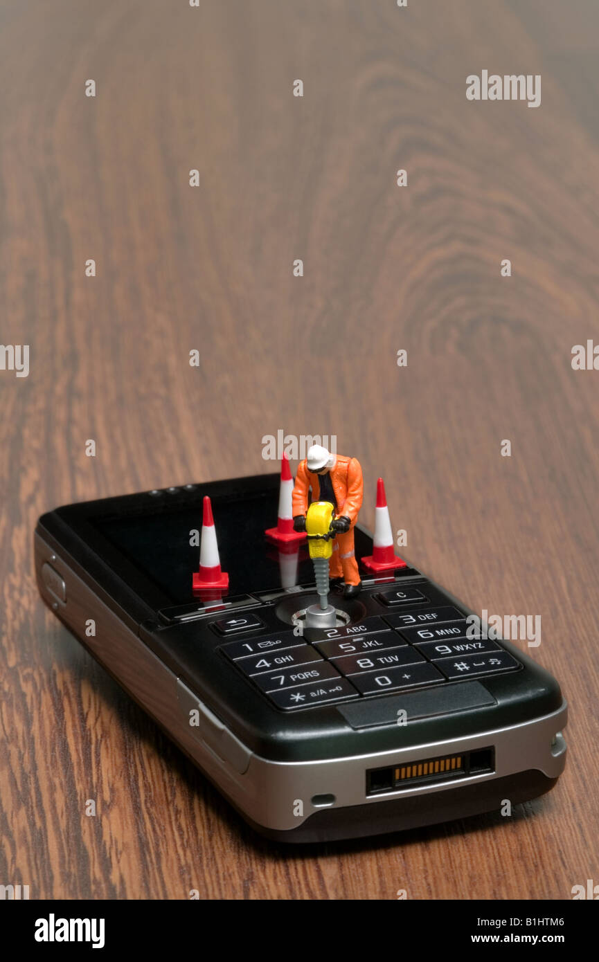 Miniatur-Arbeiter, die ein Handy Reparatur Stockfoto