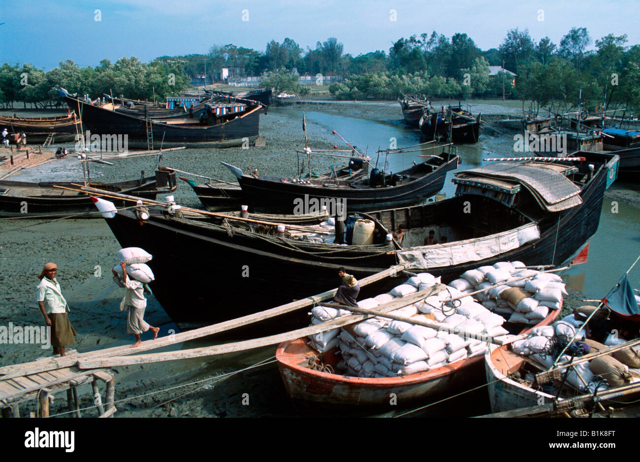 Mann entladen Reis aus Sampan Moheskhali Insel in der Nähe von Cox s Bazar Bangladesch Stockfoto