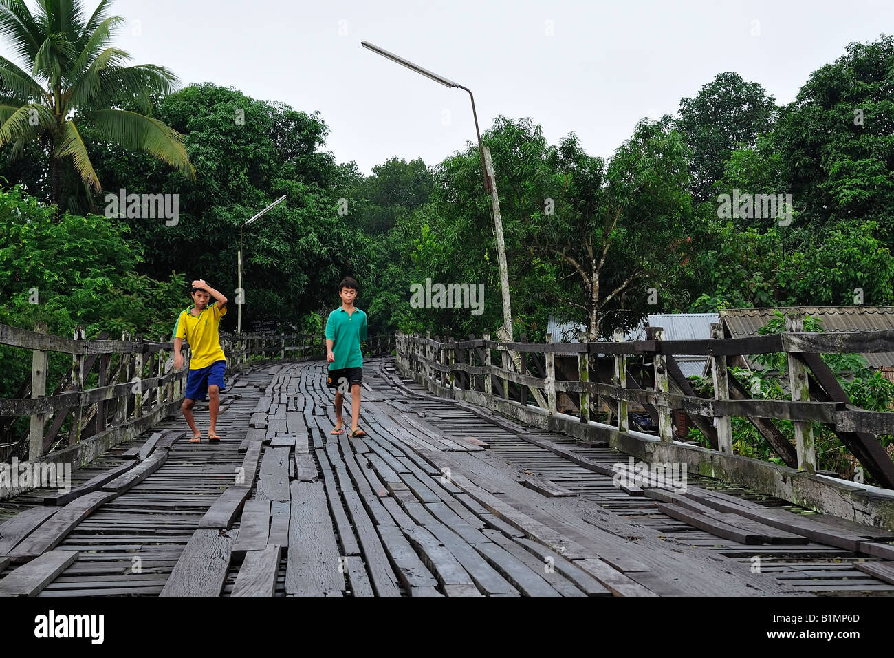 Mo Stammes-Kinder zu Fuß auf die längste hölzerne Brücke von Thailand Stockfoto