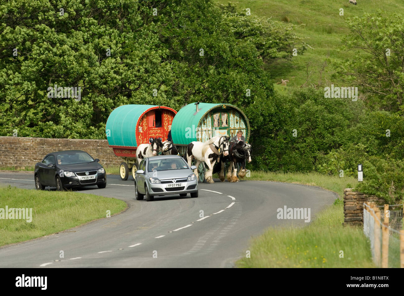 Pferd gezogenen Wohnwagen auf die Straße in Richtung Appleby horse fair auf A683 zwischen Sedbergh und Kirkby Stephen, von Autos überholt Stockfoto