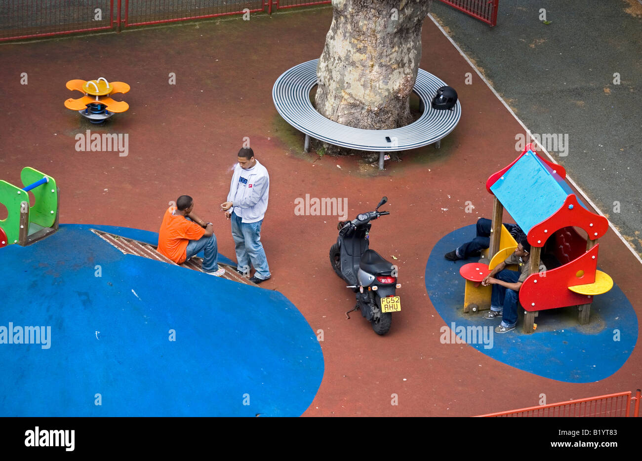 Jugendliche Herumlungern in Kinderspielplatz London England Großbritannien UK Stockfoto