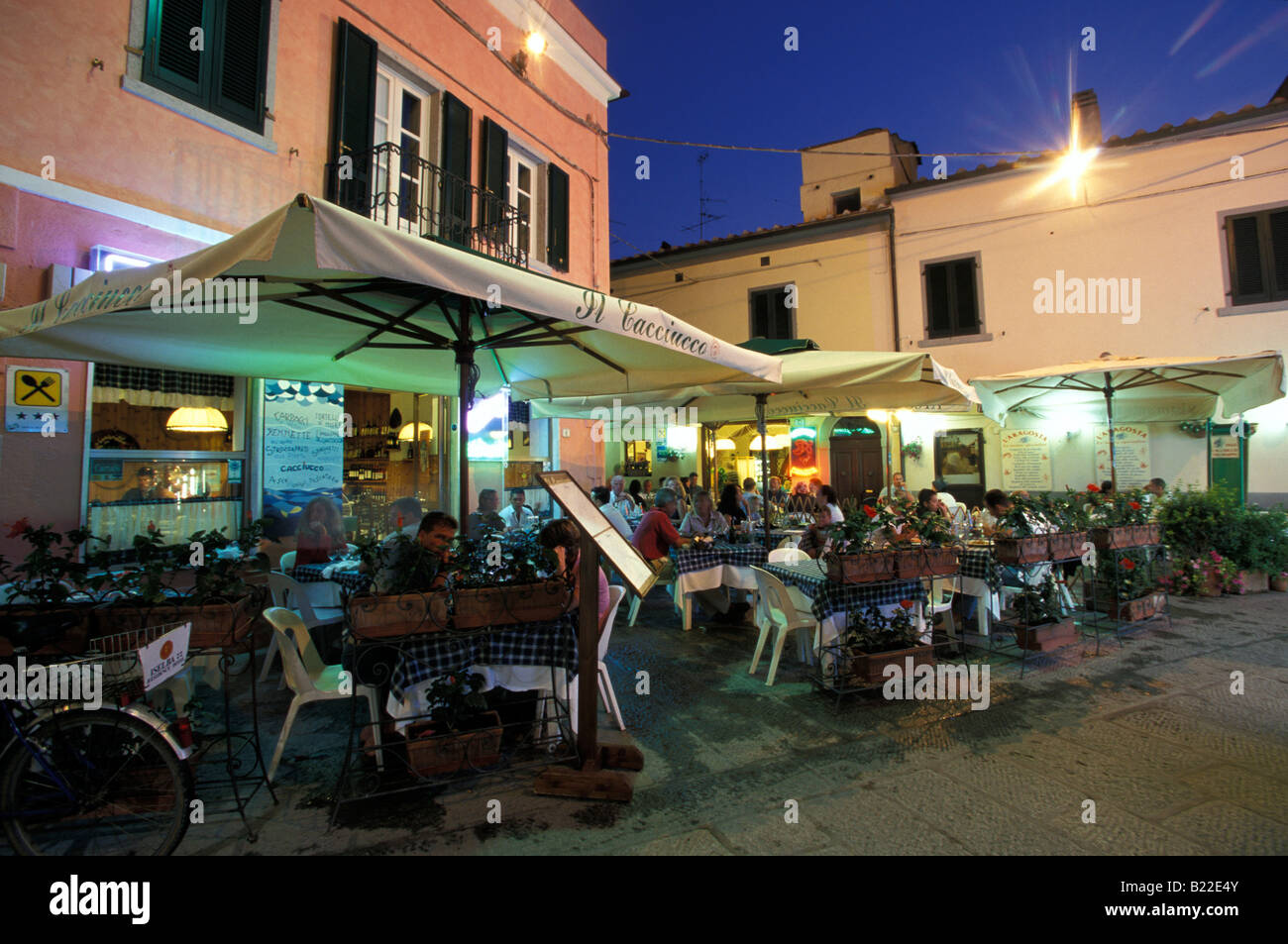 Leute sitzen im Open-Air-Bereich eines Restaurants am späten Abend Marina di Campo-Insel Elba-Toskana-Italien Stockfoto