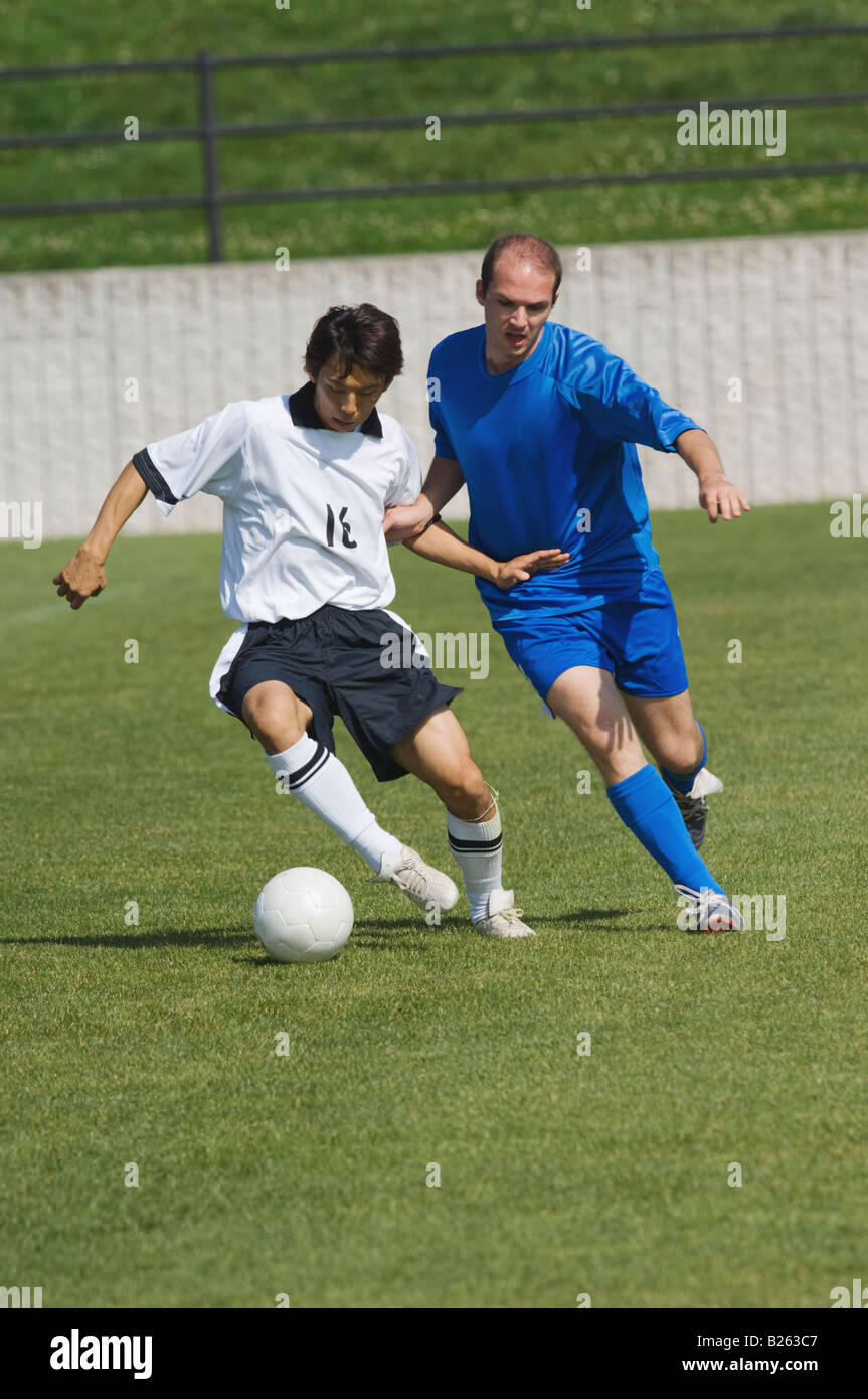 Fußball-Spieler den Ball zu schützen Stockfoto