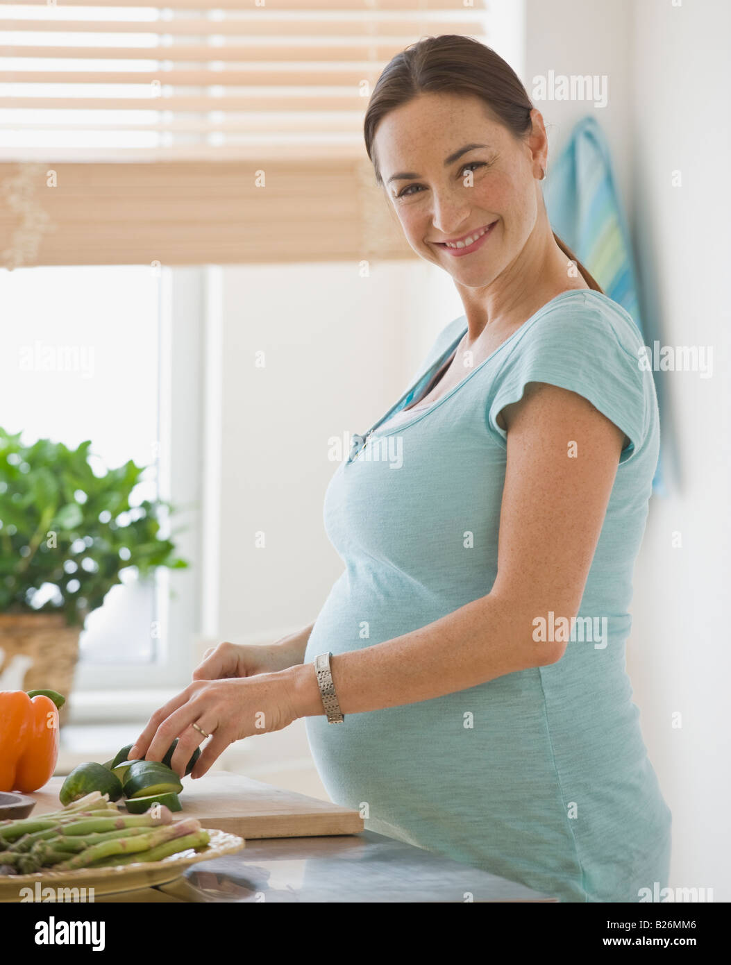 Hispanic schwangere Gemüse Hacken Stockfoto