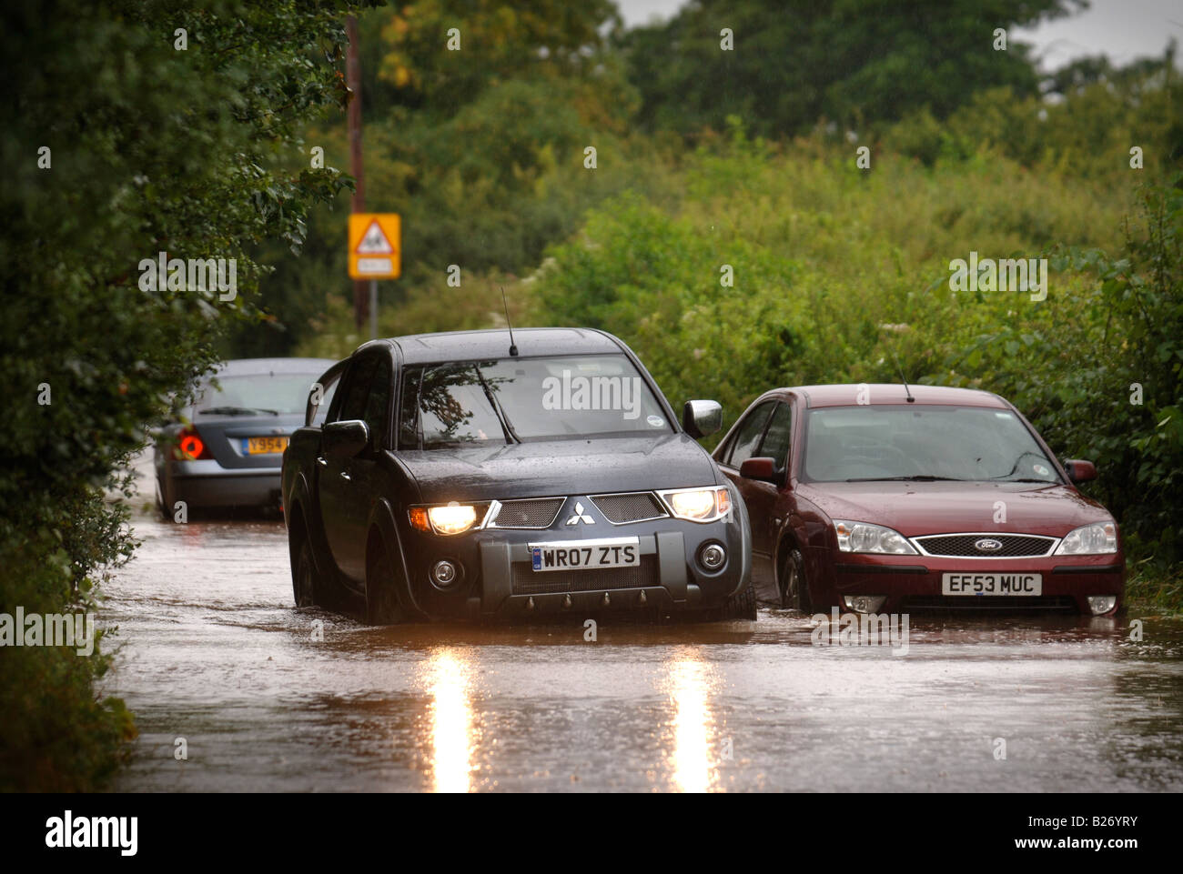 AUTOS ZU VERHANDELN HOCHWASSER IN EINER WOHNSTRAßE WÄHREND DES HOCHWASSERS IN GLOUCESTERSHIRE JULI 2007 BRITISCHE FAHRZEUGE MIT NIEDRIGEN LUFTEINLASS Stockfoto