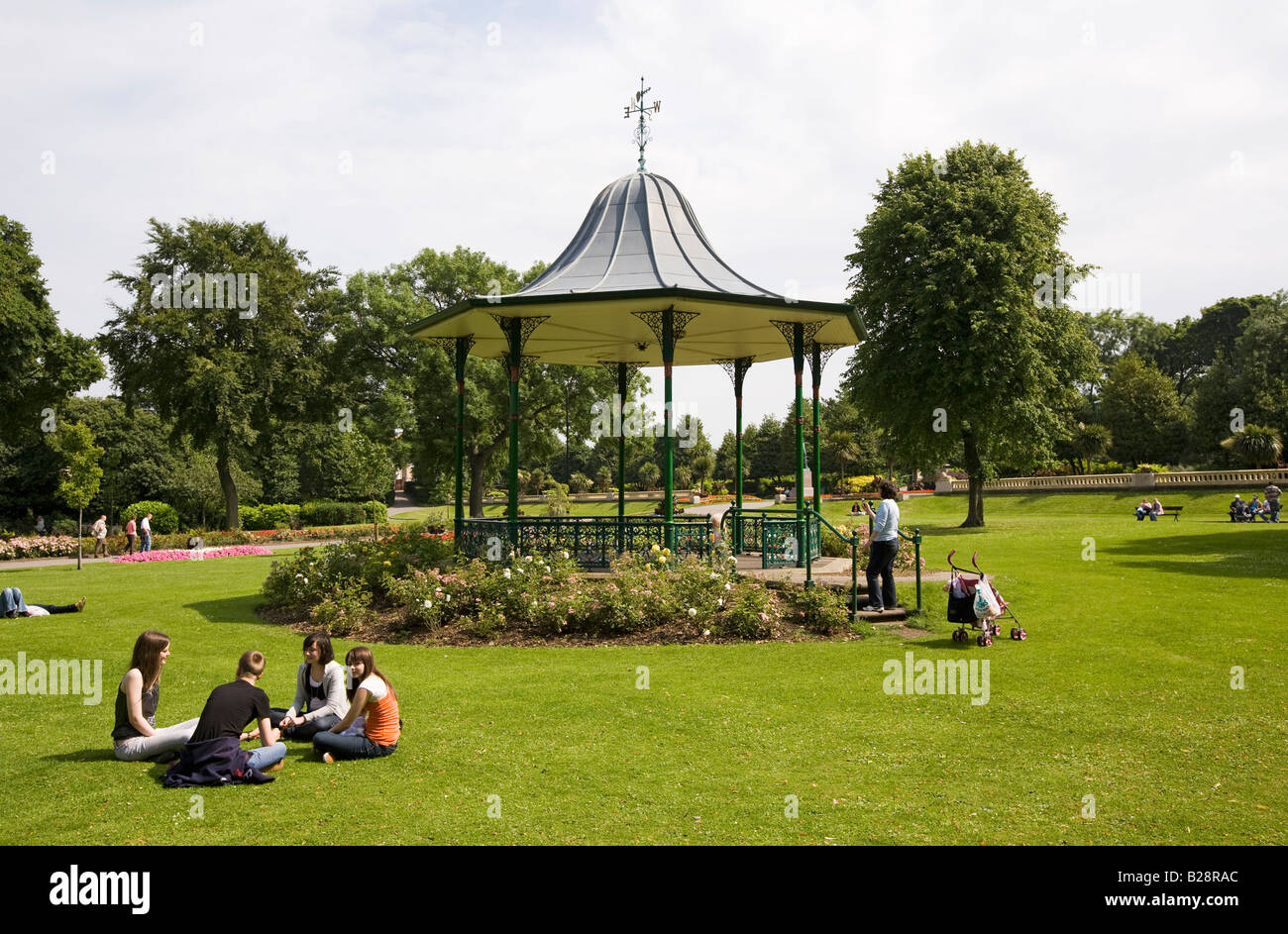 UK-Tyne and Wear Sunderland Mowbray Park Gardens Menschen im Chat auf Rasen in der Nähe von Musikpavillon Stockfoto