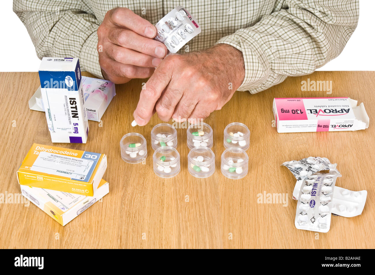 Ein älterer Mann seine tägliche Dosis Pillen Sortierung Container berücksichtigen. Stockfoto