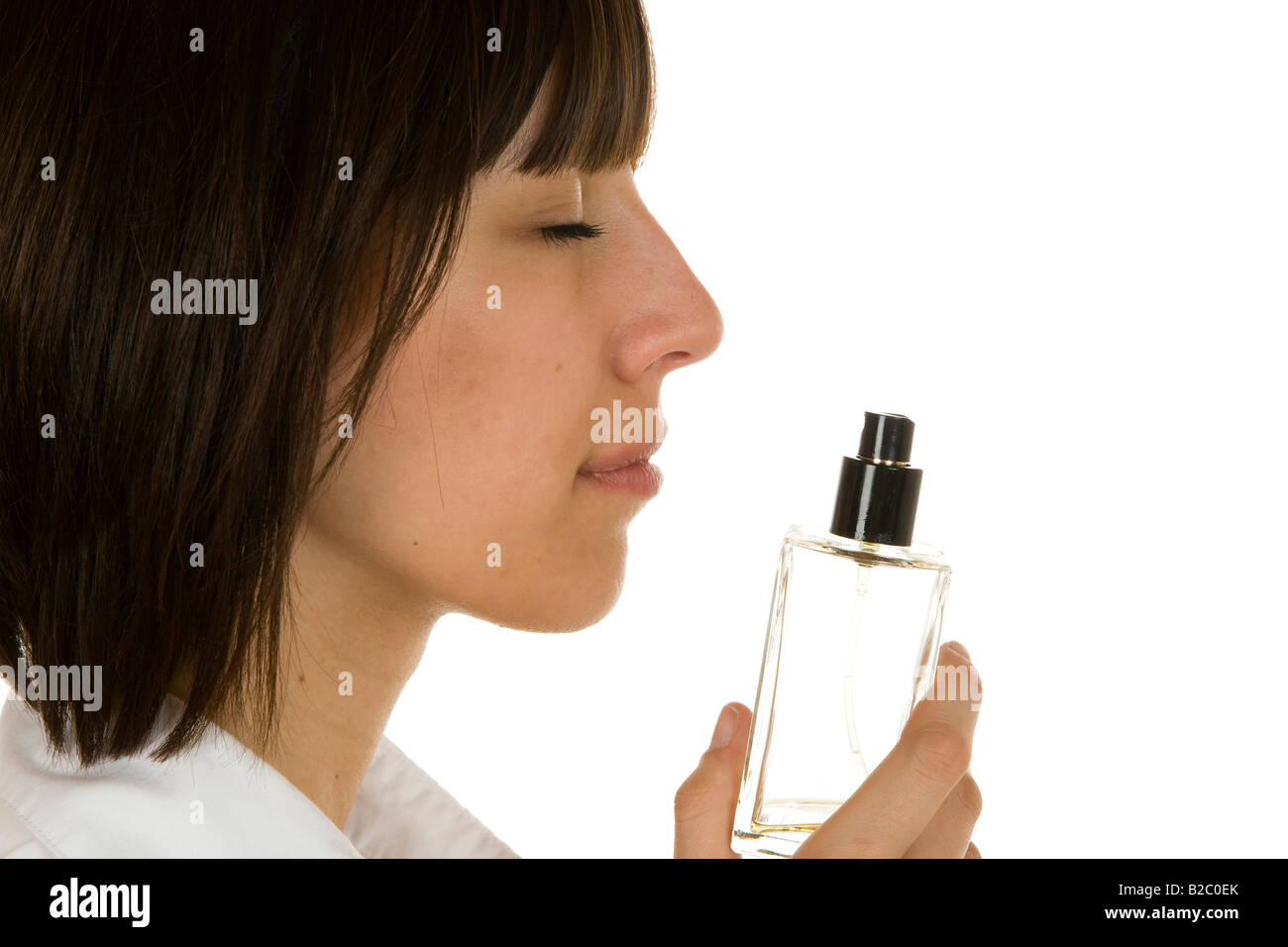 20-jährige Frau schnüffeln eine Parfüm-Flasche Stockfoto