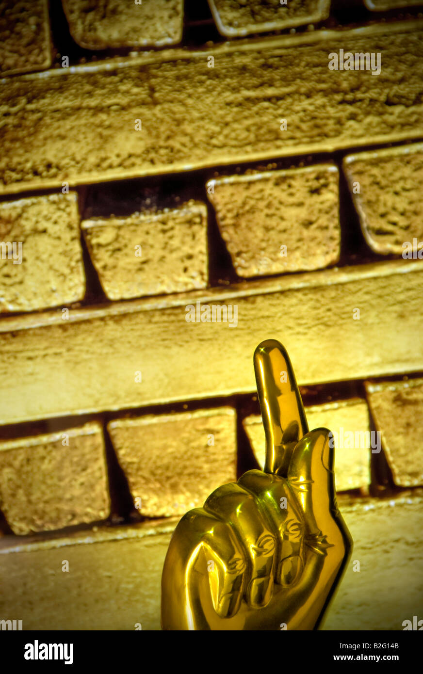 Konzept-Bild der zunehmenden globalen Preis des Goldes mit "Gold Finger" nach oben mit solid gold Barren hinter Stockfoto