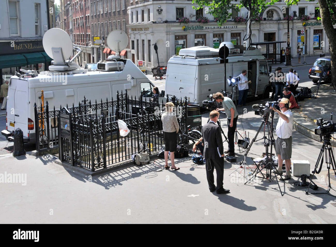 Gegenüber von Royal Courts of Justice Law Courts Journalisten und Reporter mit TV-Kamerateams, die neben der Satellitenschüssel Van London UK Nachrichten schreiben Stockfoto