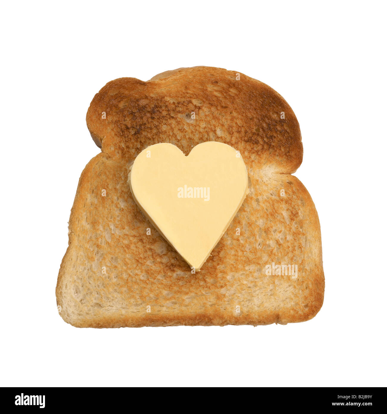Scheibe Toast mit herzförmigen Stückchen butter Stockfoto
