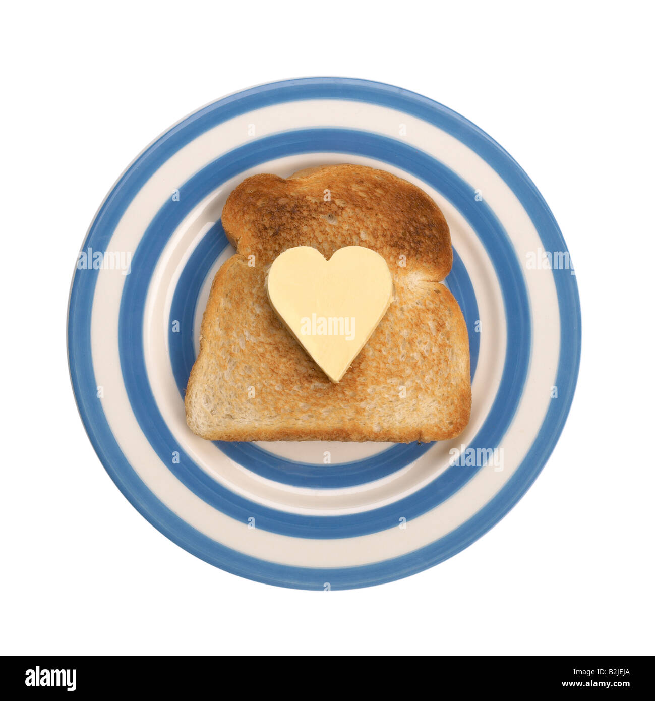 Scheibe Toast mit herzförmigen Stückchen butter Stockfoto
