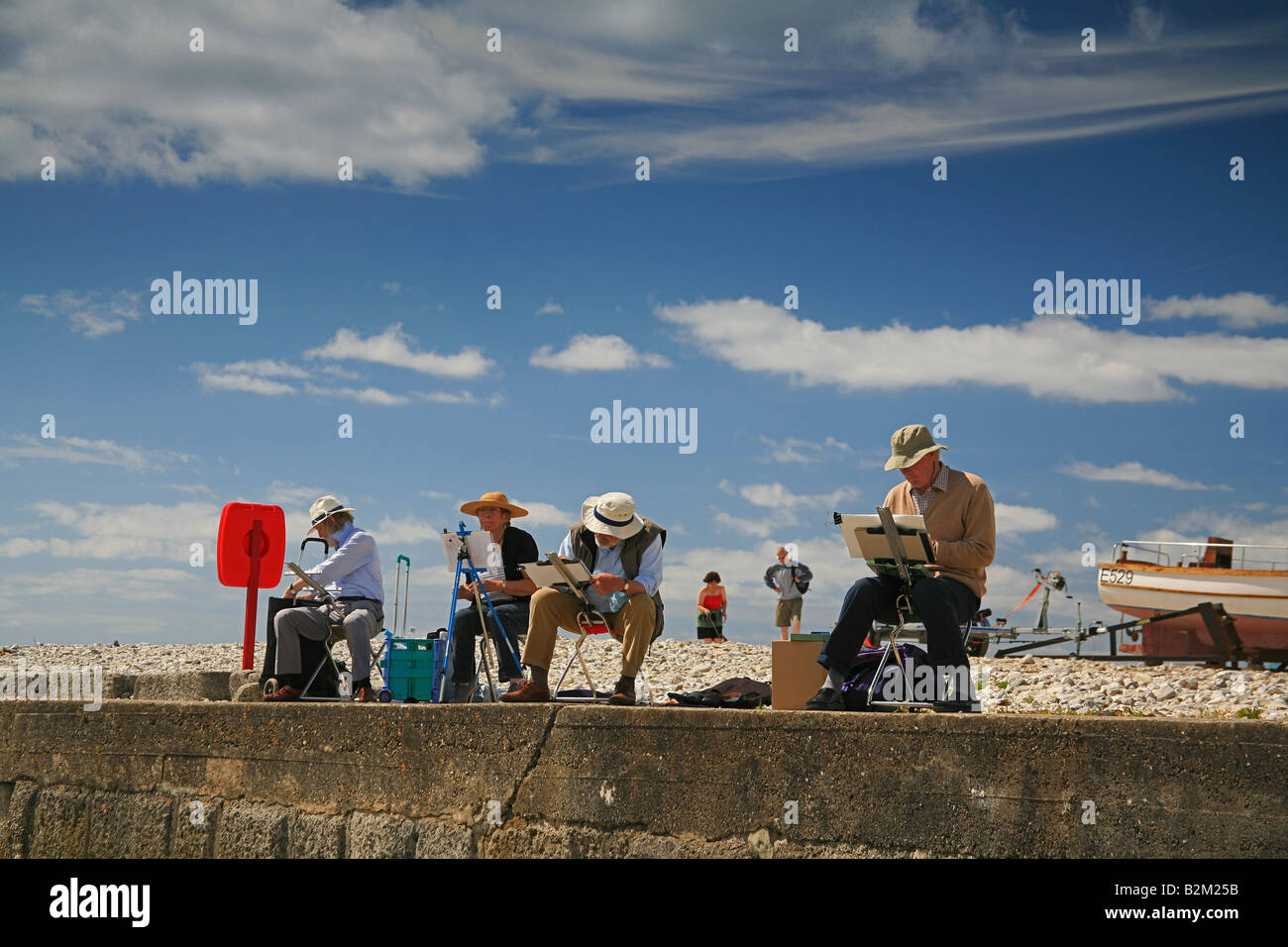 Künstler bei der Arbeit an The Cobb, Lyme Regis, Dorset, Großbritannien Stockfoto