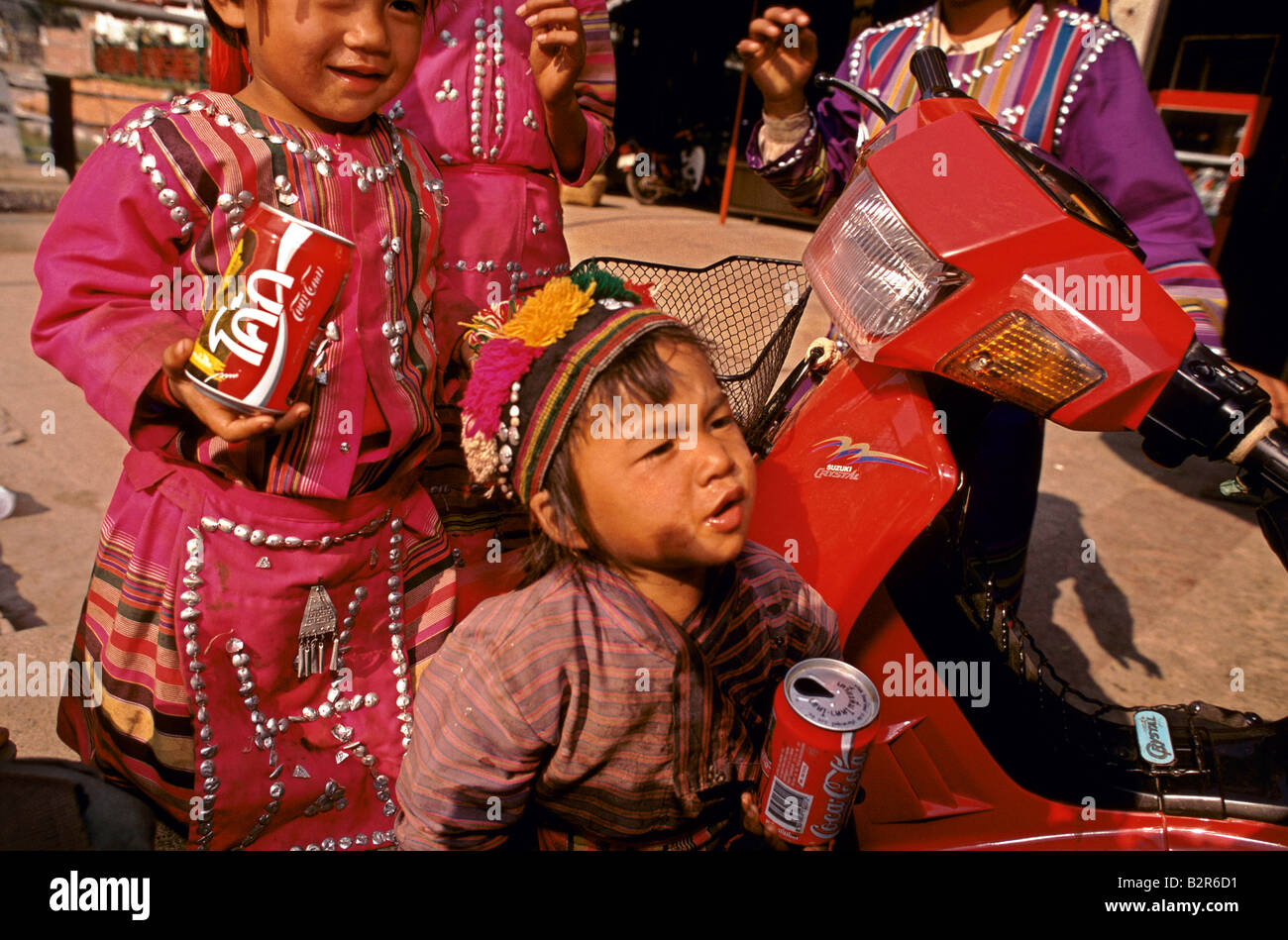 Kinder in Tracht mit thai Coca Cola-Dosen Stockfoto