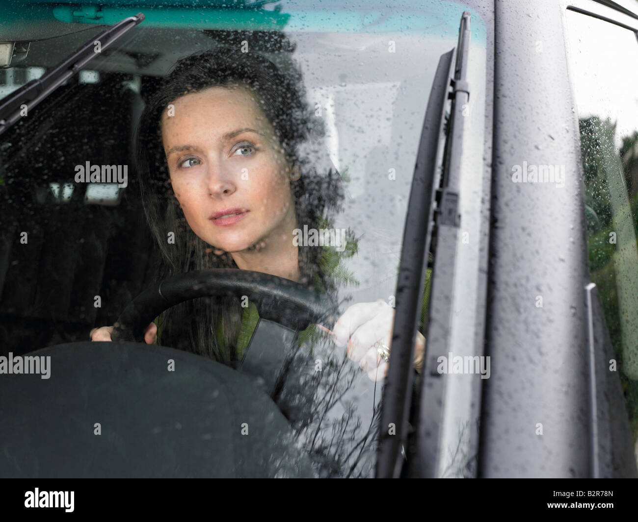 Autofahrerin, Regen fällt Stockfoto