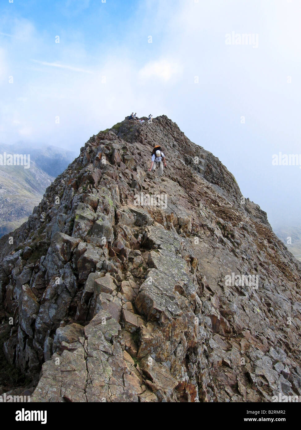 Ein Walker vorsichtig verhandelt Crib Goch, während andere zu auf dem Gipfel Mittag Stockfoto