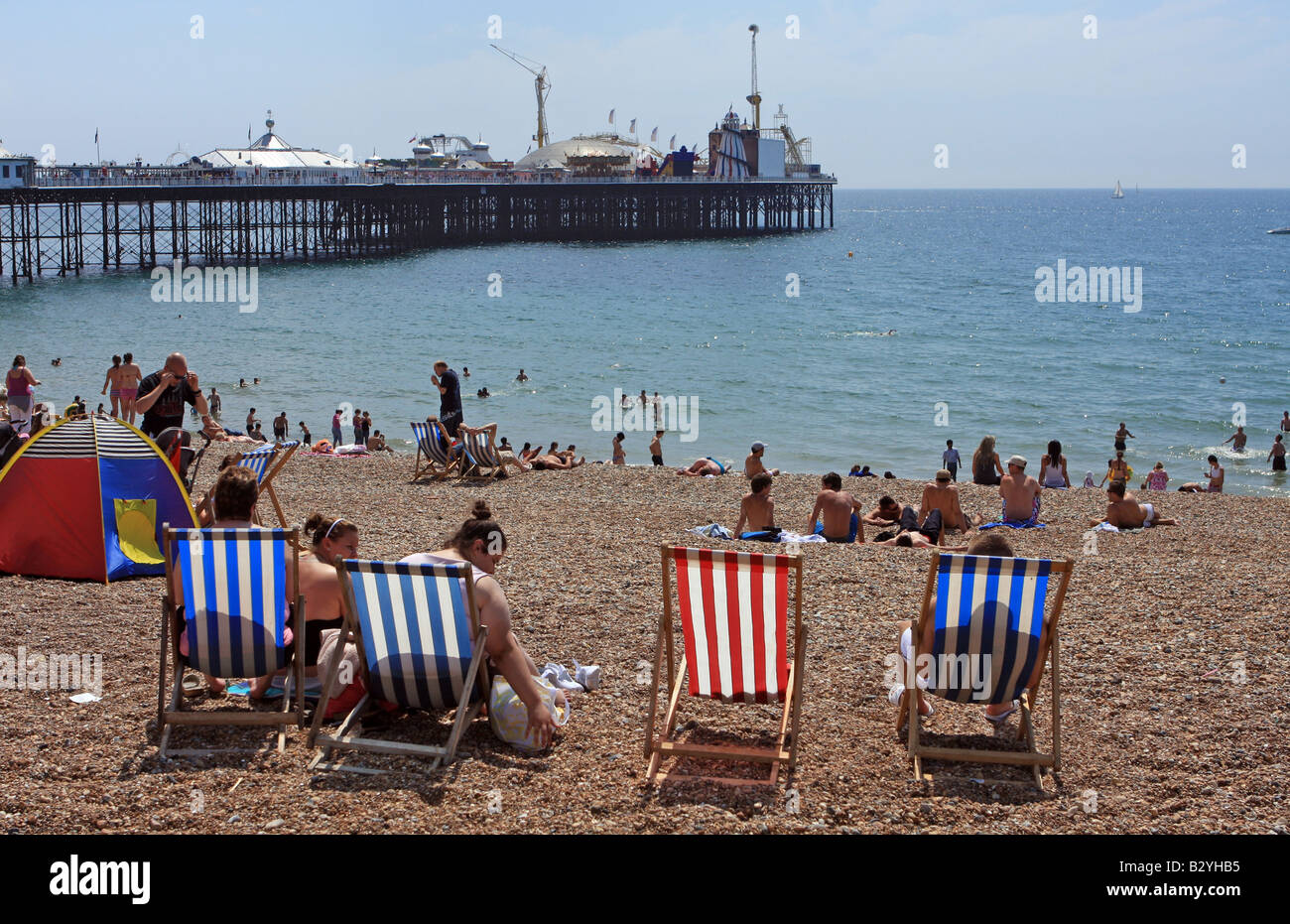 Menschen entspannen am Brighton Strand an einem sonnigen Sommertag Stockfoto