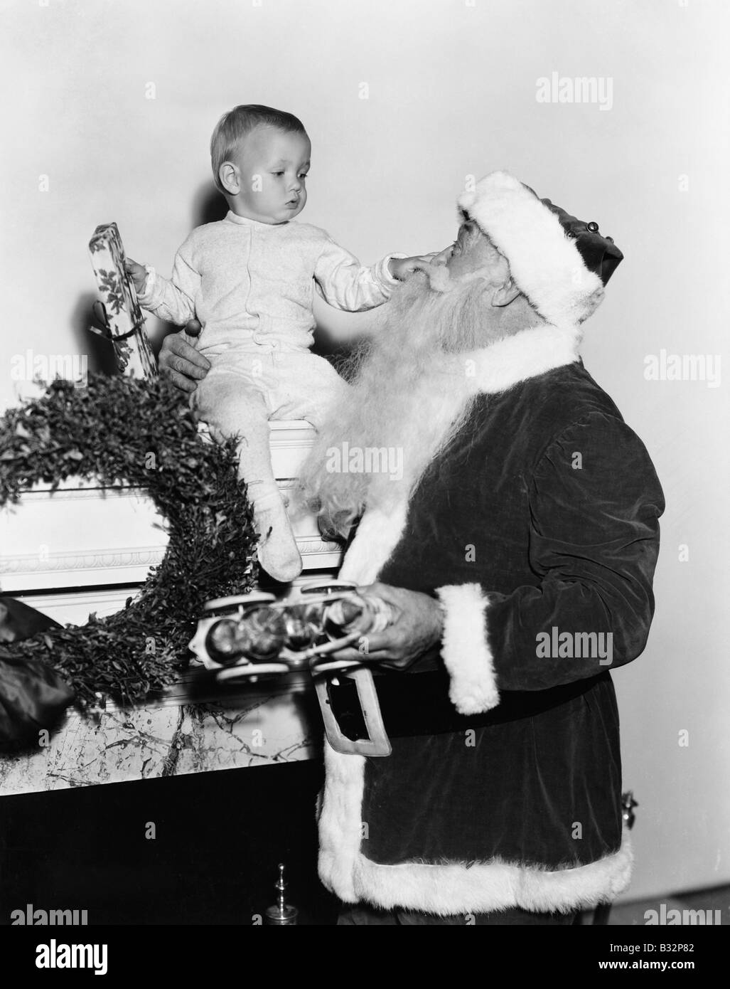 Santa Claus mit Baby Mantel Stockfoto