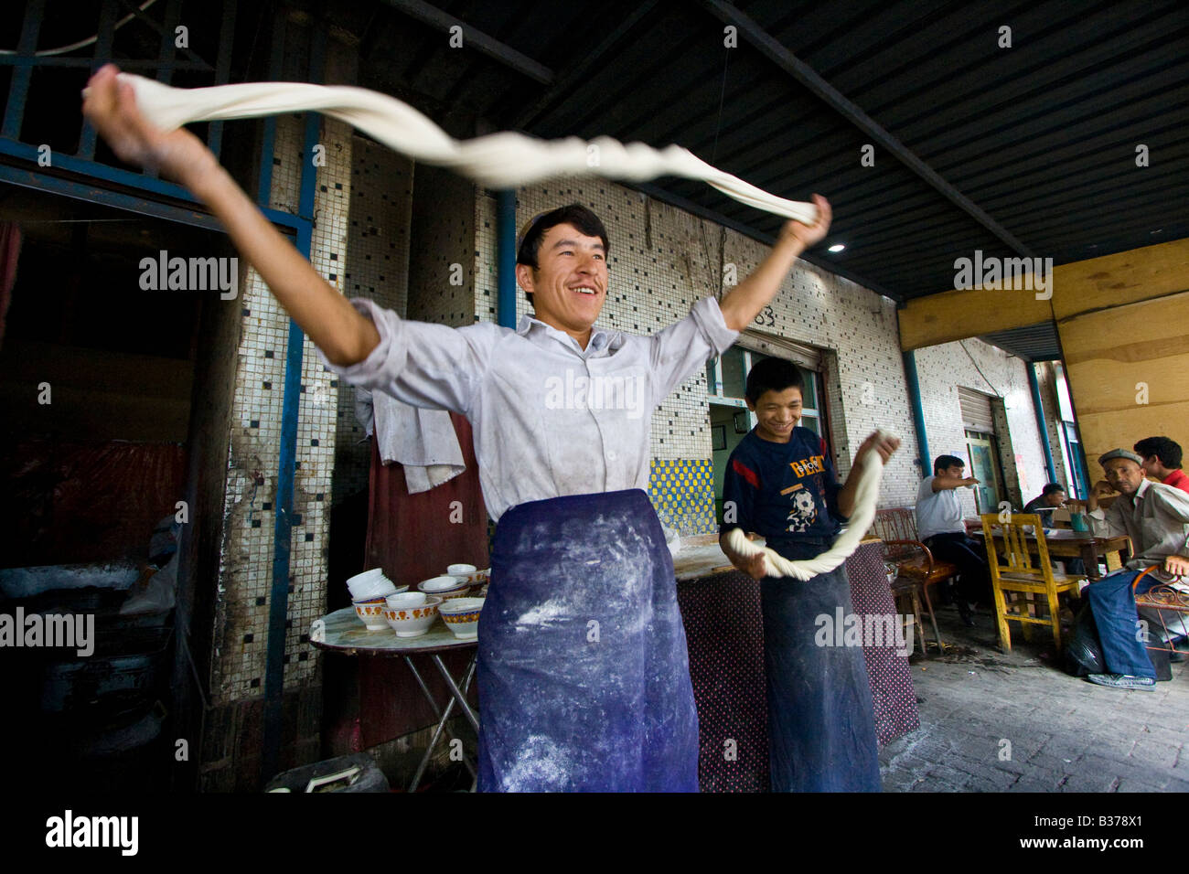 Uyghur Mann machen frische Laghman Nudeln auf dem Sonntagsmarkt in Kashgar in der Provinz Xinjiang in China Stockfoto