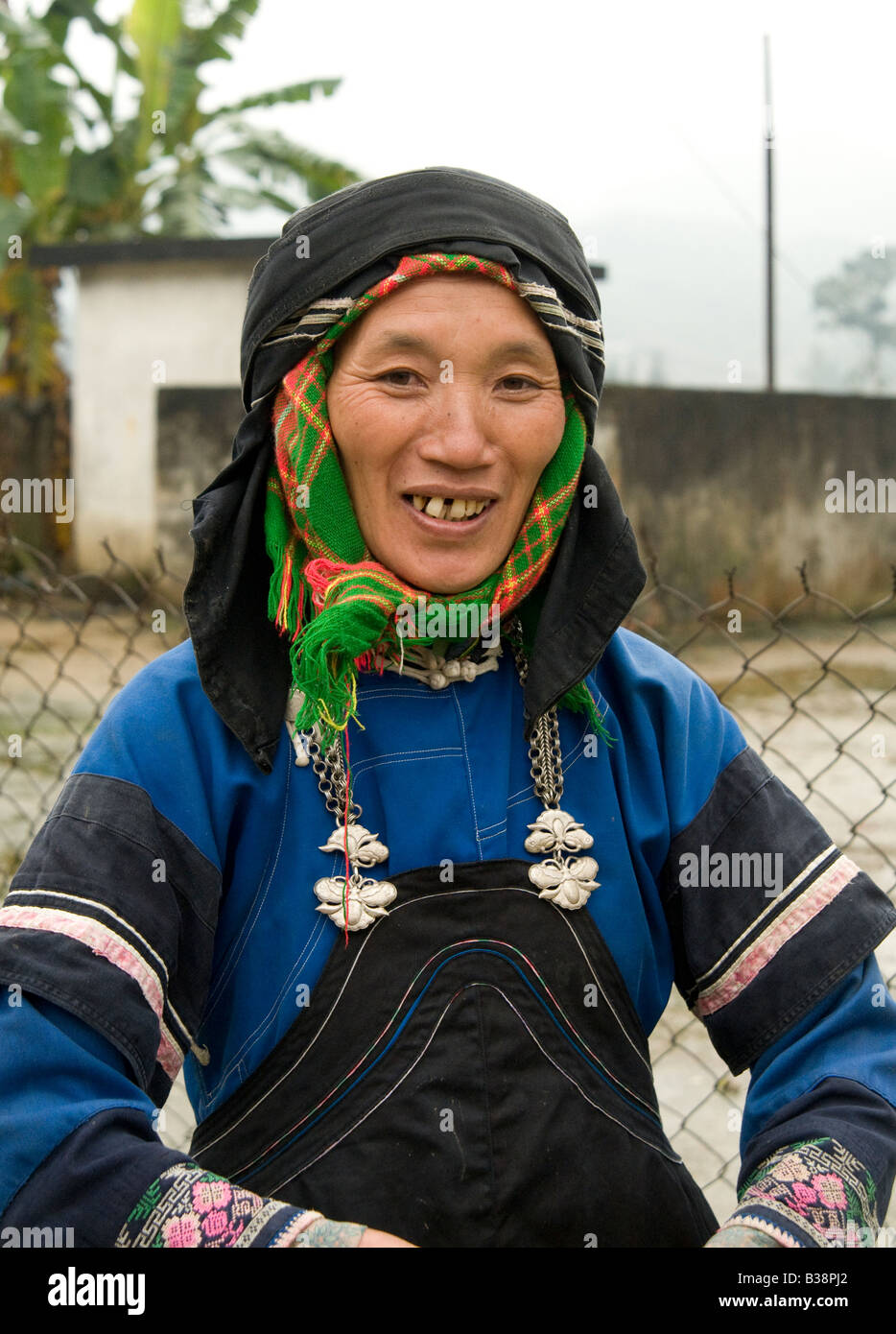Glücklich lächelnd schwarze Hmong Frau, die traditionelle Tracht auf einem Markt in Nordvietnam trägt Stockfoto