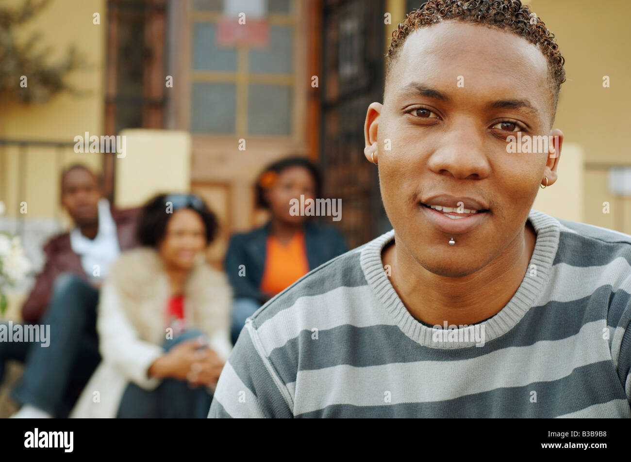 Afrikanischer Mann mit Freunden im Hintergrund Stockfoto