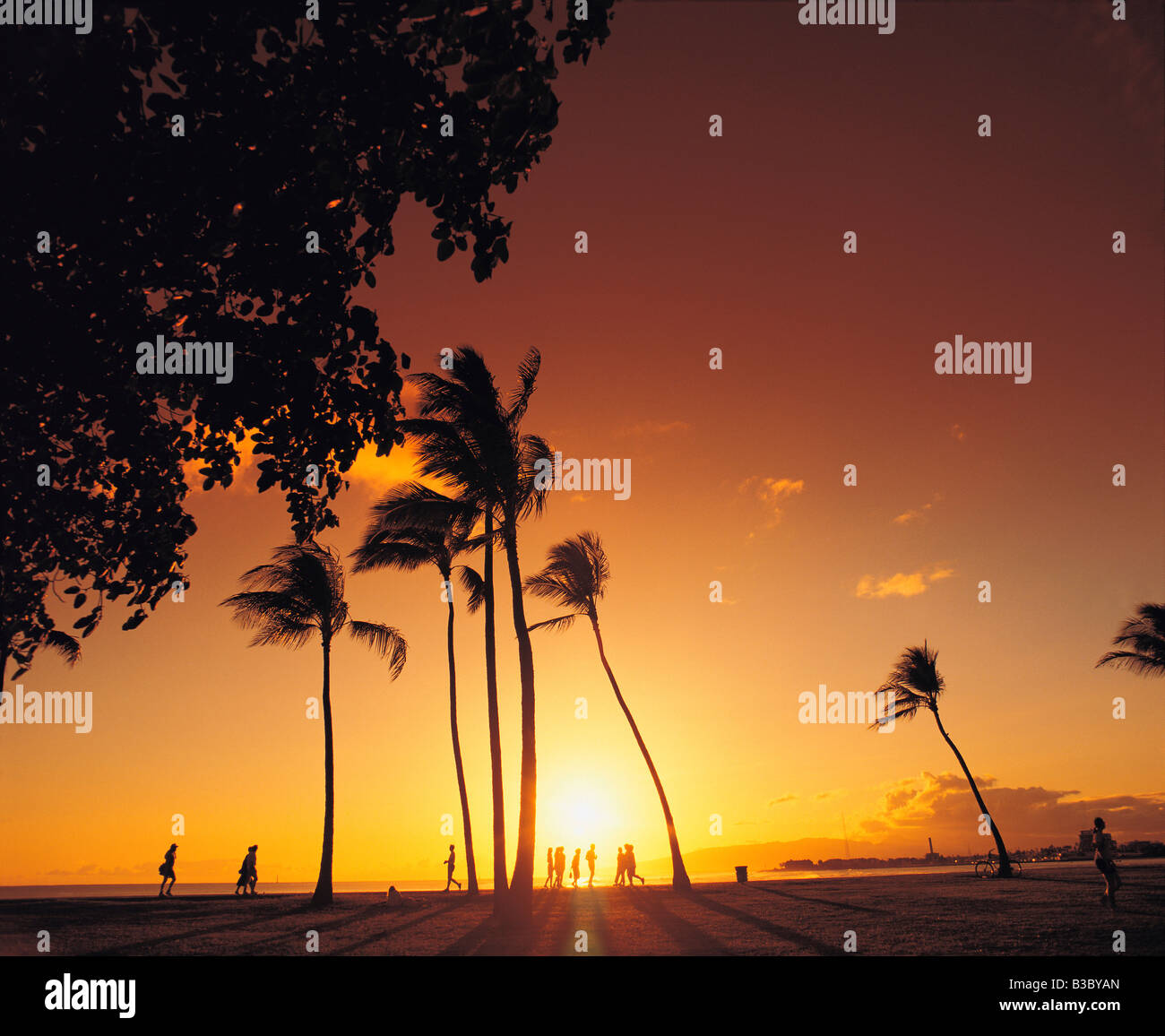 Menschen am Strand bei Sonnenuntergang, Honolulu, Hawaii, Waikiki, USA Stockfoto