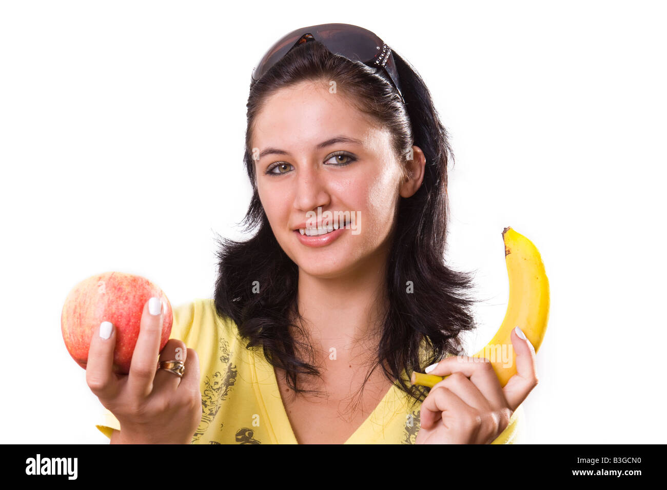 Junge Frau mit Banane und Apfel Stockfoto