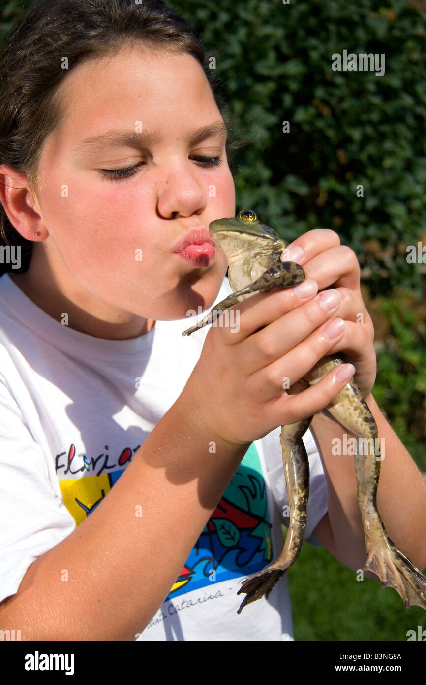 11 Jahre altes Mädchen küssen ein Ochsenfrosch in Boise, Idaho Stockfoto