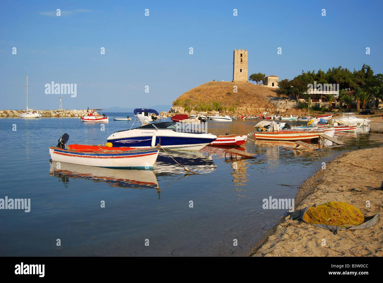 Blick auf Hafen und Turm von St. Paul bei Sonnenuntergang, Nea Fokea, Halbinsel Kassandra, Chalkidiki, Zentralmakedonien, Griechenland Stockfoto