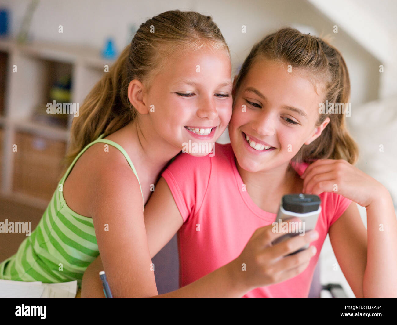 Junge Mädchen spielen mit einem Handy Stockfoto