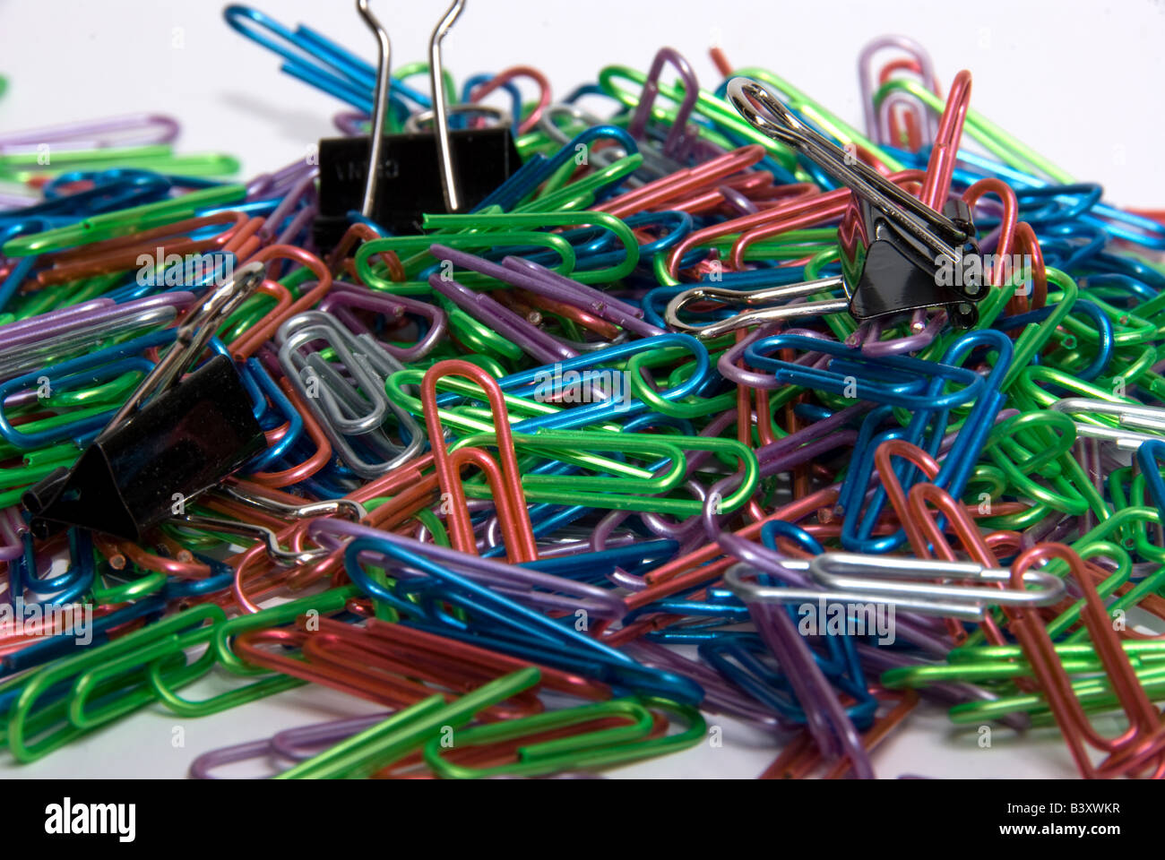 Haufen von farbigen Büroklammern mit ein paar Binder clips Stockfoto