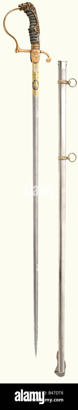 König Wilhelm II. (1848 - 1921) - ein Präsentationsschwert, Schwere, gerade, Damaszener Klinge, an der Basis fein geätzt und vergoldet, die obverse Seite mit dem kaiserlichen Wappen, die Rückseite mit "Eisenhauer-Damaststahl" beschriftet. Bläserknäuel mit eingravierten Schlieren, der obverse mit der Chiffre "W" unter einer Krone, der umgekehrte mit dem ebenfalls bekrönten württembergischen Wappen. Die Rückplatte ist reliefiert, der Knauf hat die Form eines Leopardenkopfes mit roten Glasaugen. Griffige Abdeckung mit dreifachem silberfarbenem Draht w, Stockfoto