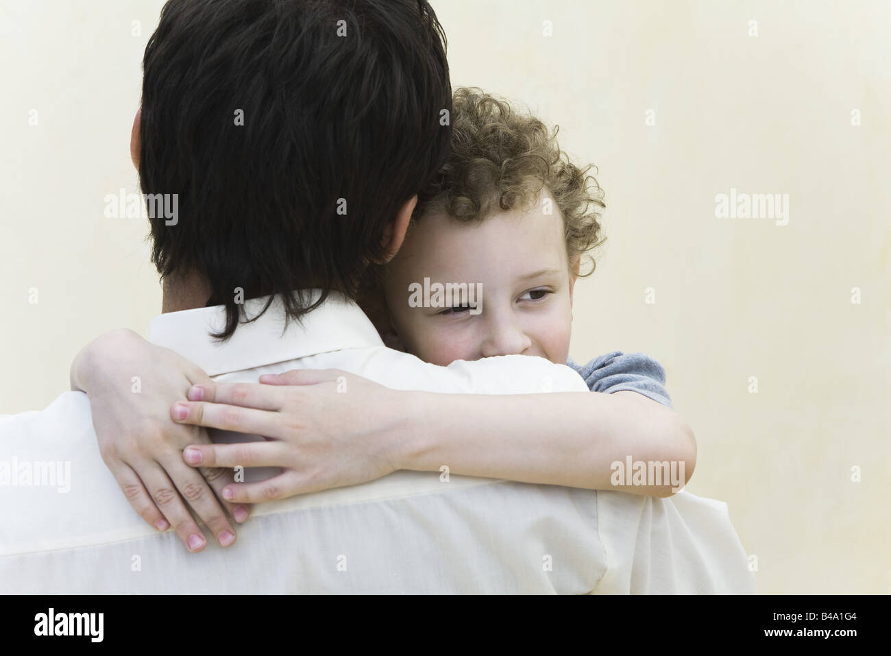 Kleiner Junge umarmte Vater, wegsehen, Nahaufnahme Stockfoto