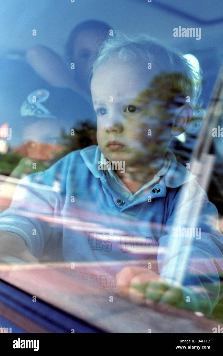 Baby im Auto am Fenster suchen Stockfoto