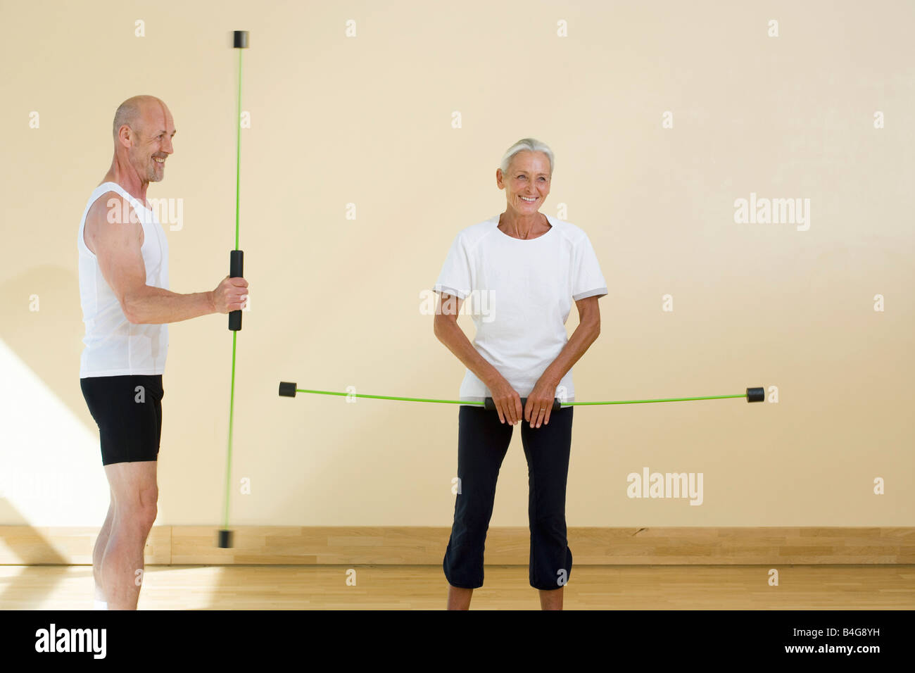 Ein reifer Mann und eine ältere Frau mit aeroben Flex Stangen Stockfoto