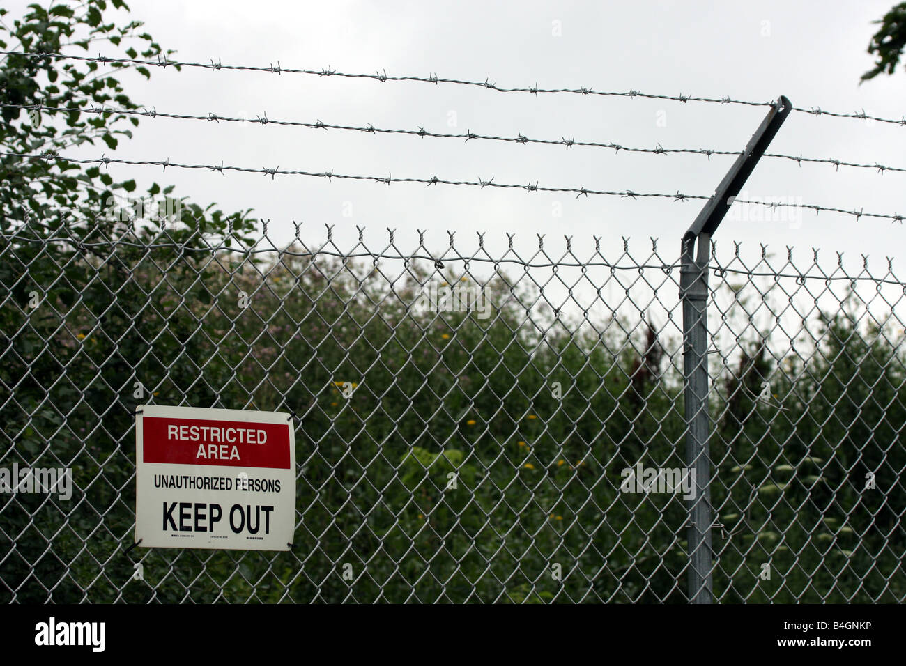 Ein Schild informiert Menschen, dass der Bereich hinter dem Zaun ein Sperrgebiet unbefugte halten, ist Stockfoto