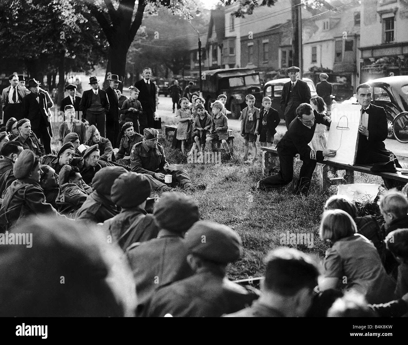 Leitender Ingenieur Andy Duncan von Glasgow unterhält die Truppen mit seinem Blitz-Skizzen, während sie darauf, für D-Day 1944 WW2 warten Stockfoto