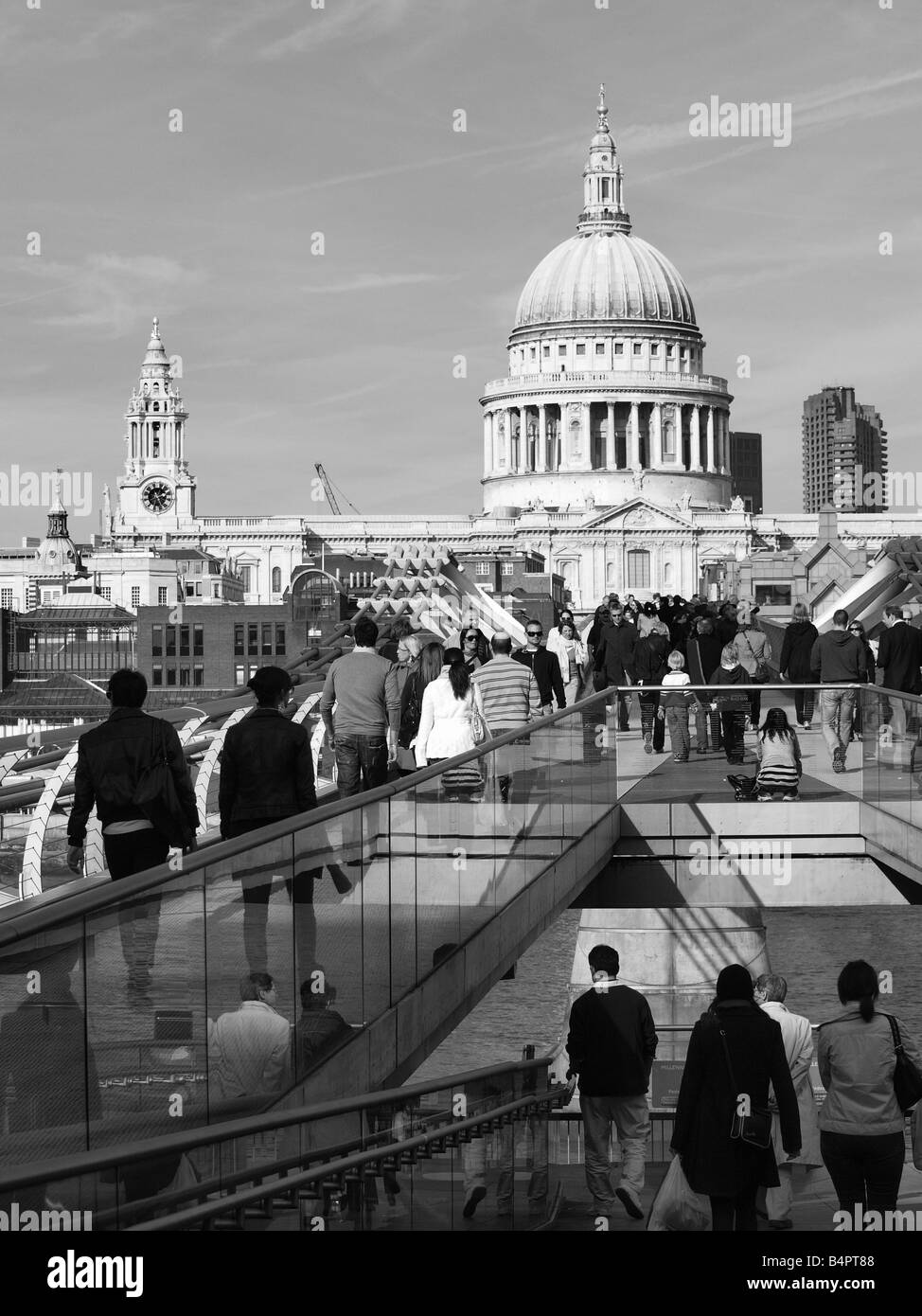 Menschen, die über die Millennium Bridge in London St Pauls Kathedrale im Hintergrund Stockfoto