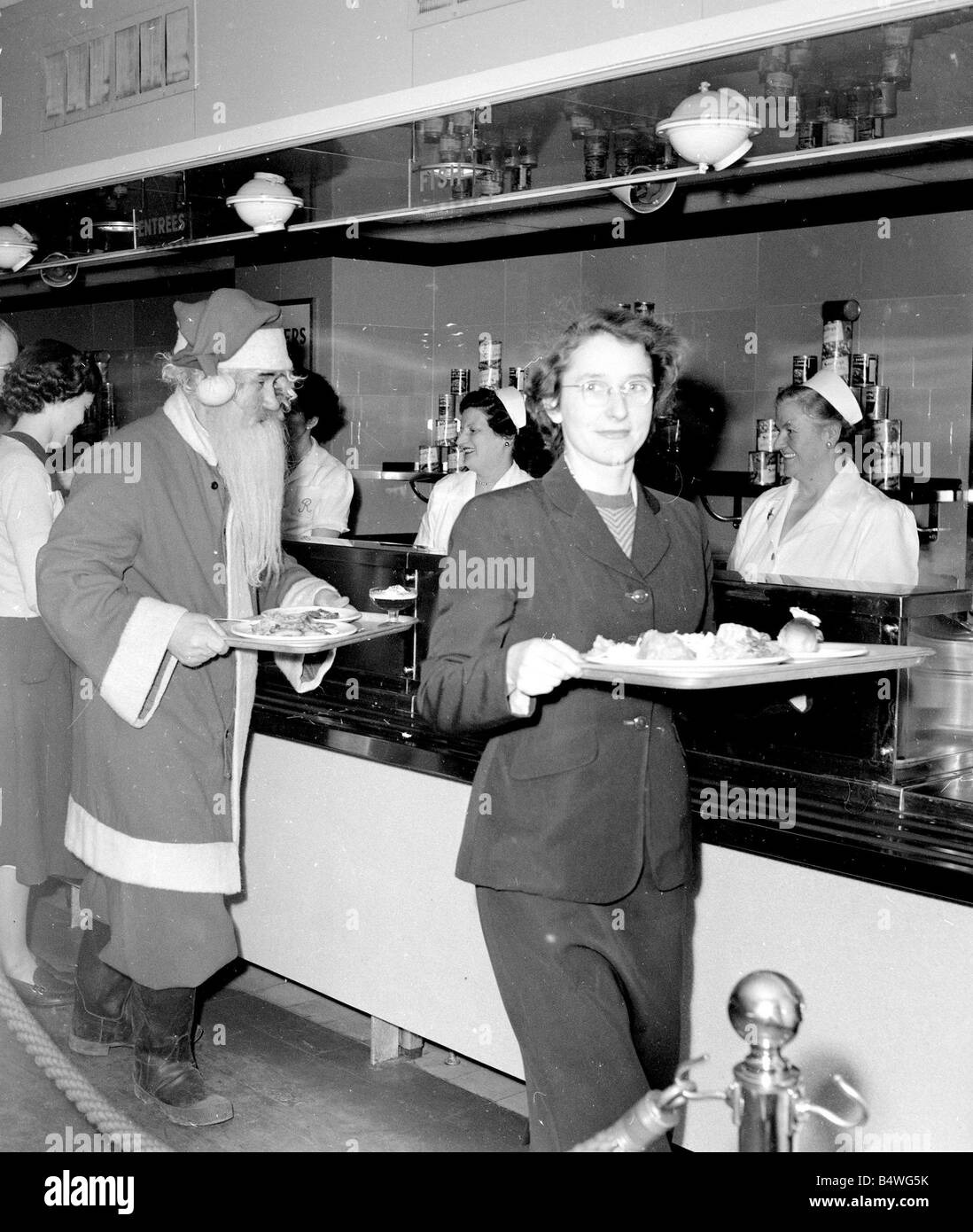 Santa Claus sammelt sein Mittagessen in der Kantine an Kingston Speicher nach einem harten Morgen Arbeit in der Grotte Dezember 1952 Stockfoto