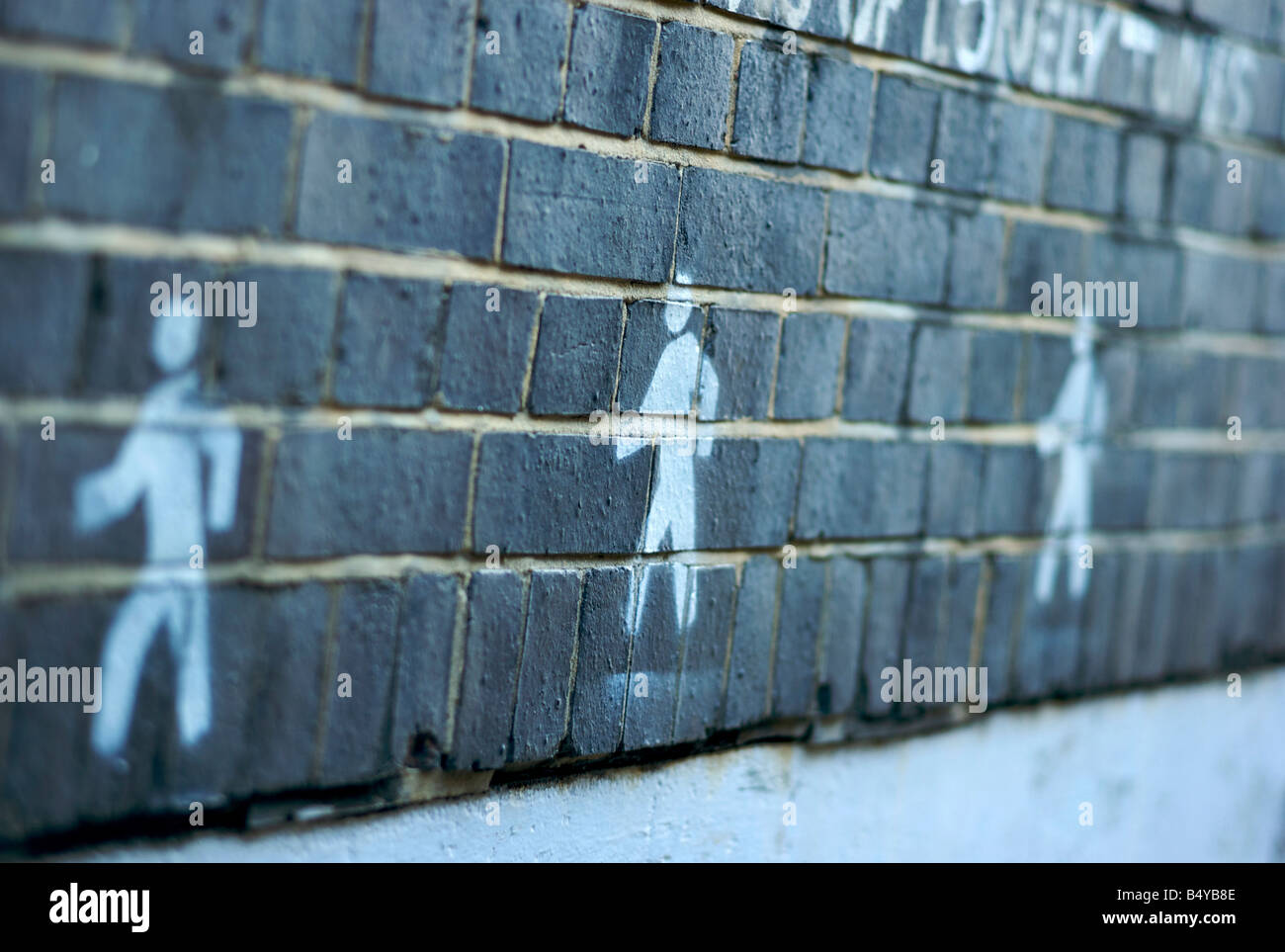 Strichmännchen, die Schablone auf eine Mauer in London UK Stockfoto