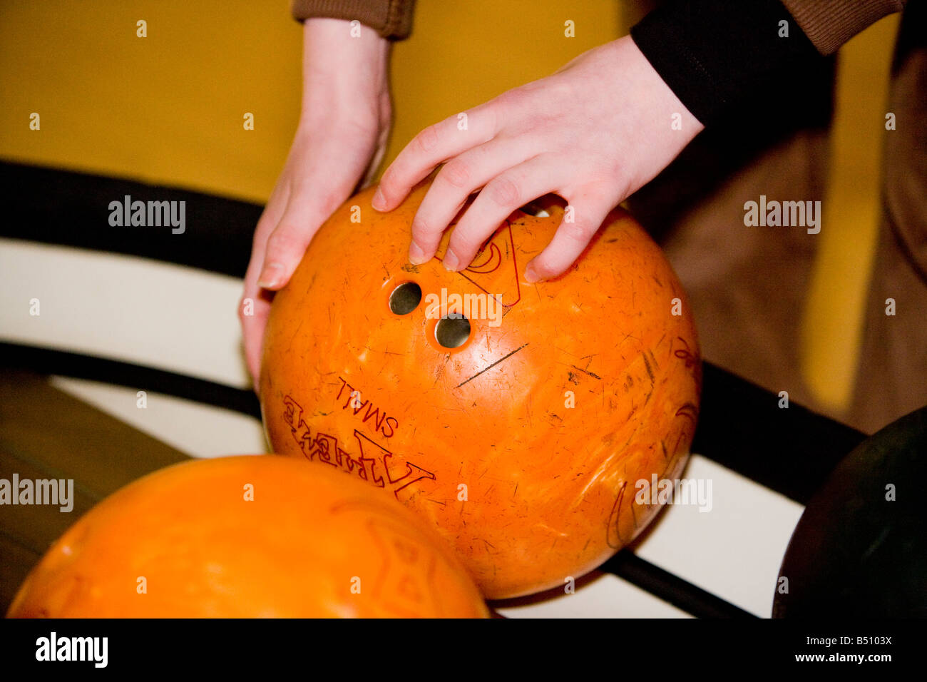 Abholung eine Bowling-Kugel Stockfoto