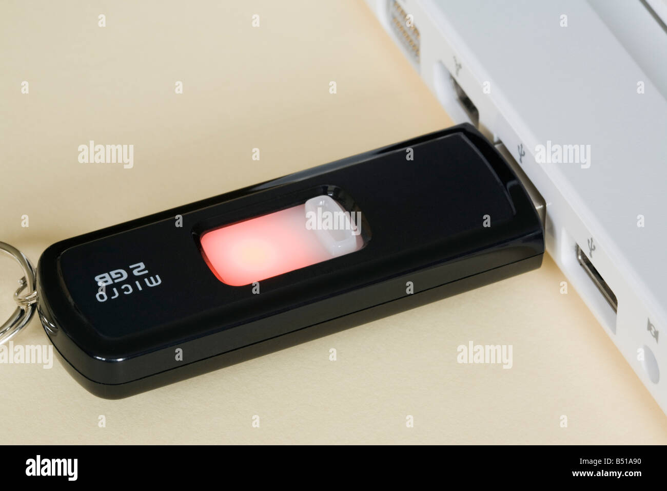 Close up of a 2GB USB stick pen drive plugged into a laptop computer usb port backing up data backup. UK Stockfoto
