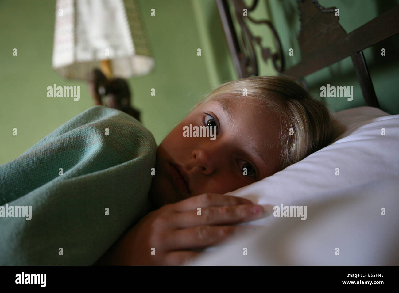 Achtjähriges Mädchen hinlegen während der Genesung von Magenverstimmung während der Reise im Ausland Stockfoto