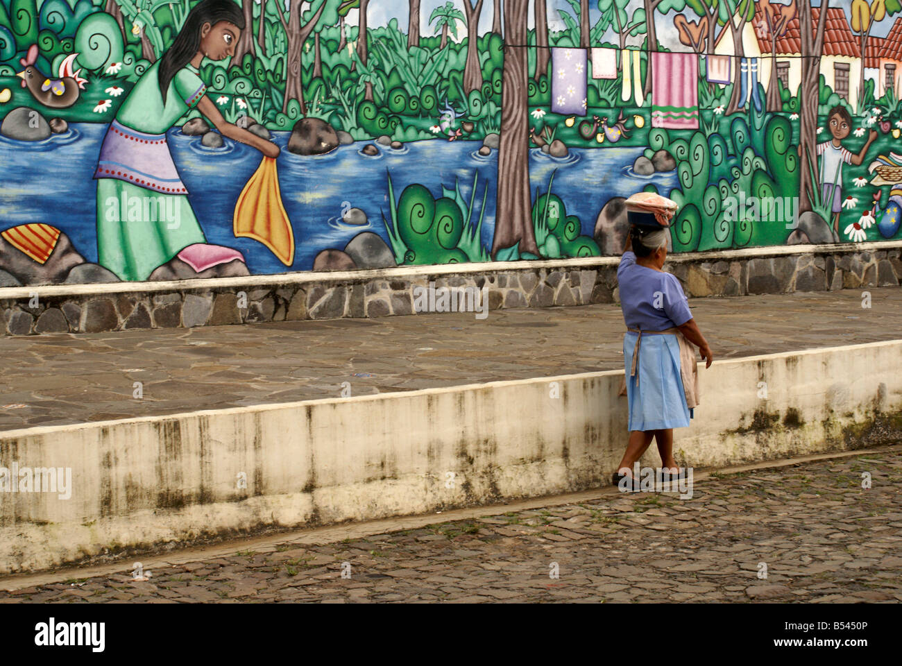 Frau vorbei gehen. Eine bunte Straße Malerei im Dorf im westlichen Ataco El Salvador Stockfoto