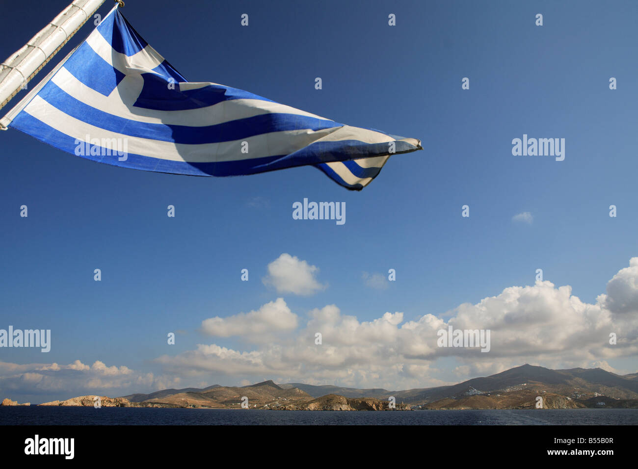 KYKLADENINSEL IOS GRIECHENLAND GRIECHISCHE FLAGGE IM WIND AUF DER RÜCKSEITE EINER FÄHRE WOGENDEN Stockfoto